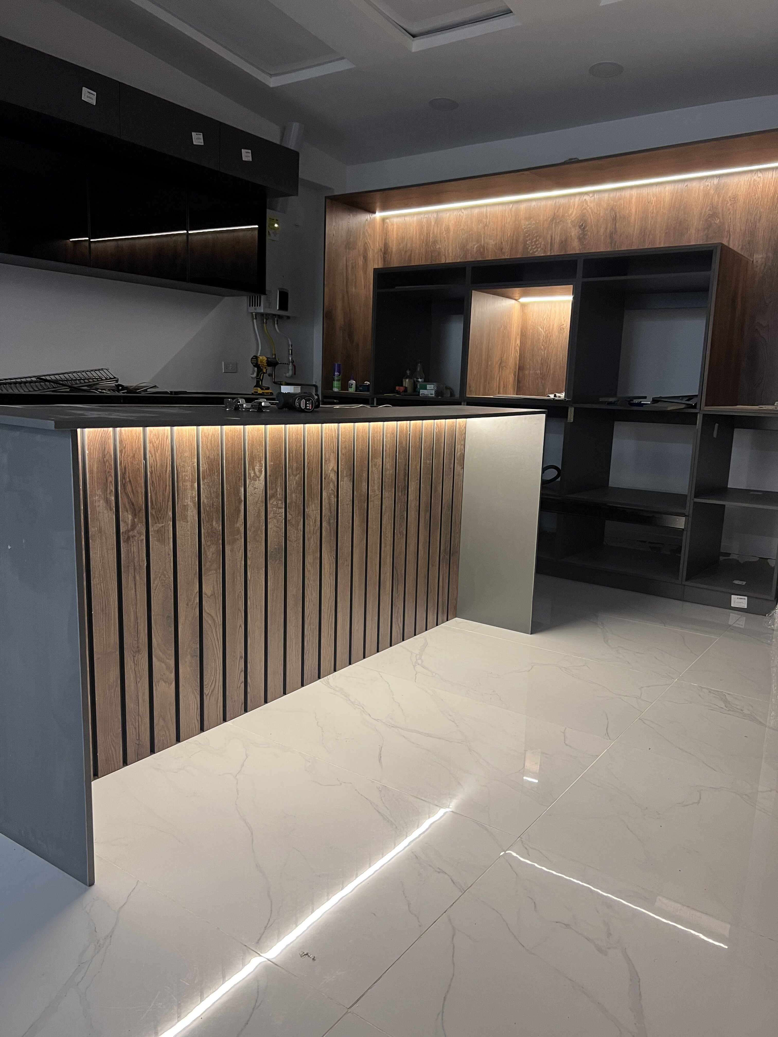 Cocina en proceso de construcción con paneles de madera y mobiliario sin terminar